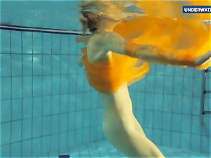 Yellow and red clothed teenager underwater